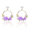 Elegant gold earrings with floral and pearl design