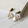 Elegant gold earrings with sparkling emeralds and delicate pearls
