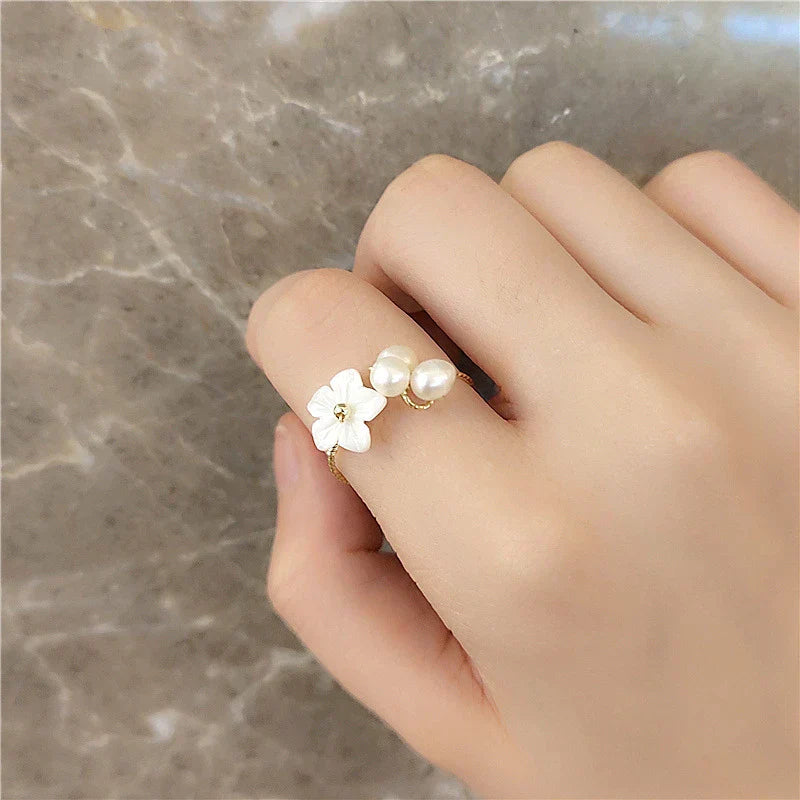 Elegant gold ring with adjustable pearl blossoms for a charming look