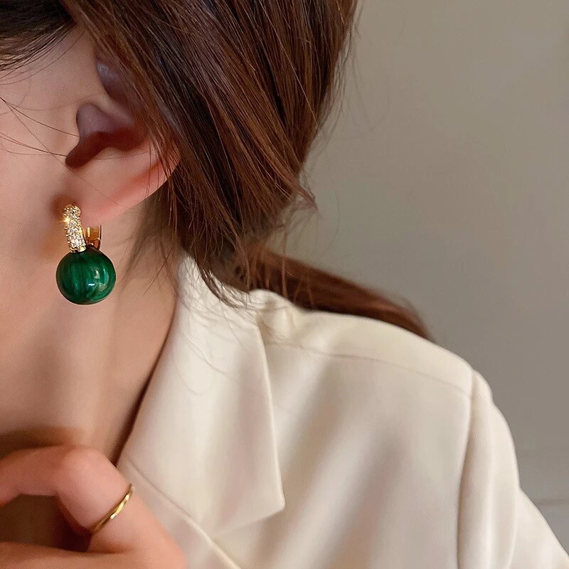 Elegant gold earrings with dazzling green pearls