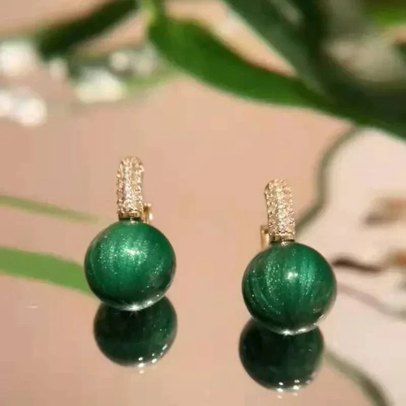 Elegant gold earrings with dazzling green pearls