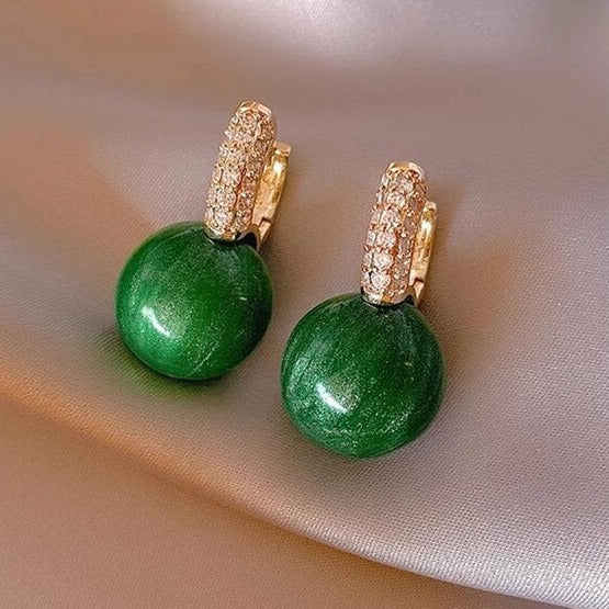 Elegant gold earrings with dazzling green pearls