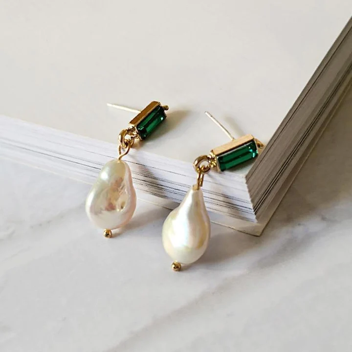 Elegant gold earrings with sparkling emeralds and delicate pearls