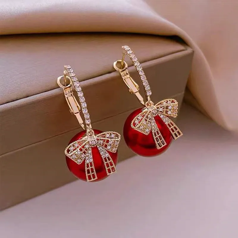 Elegant tie with sparkling red pearl earrings
